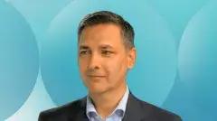 A photo of Keiron Myall against a blue background in Customs Support Group Colours.